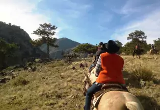 Women riding horses in the mountains