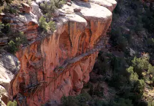 Historical hanging flume structure built on the side of a cliff