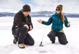 Ice fishing on a frozen lake