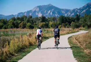 Cyclists head west toward the Flatirons