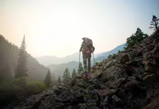 A bow hunter with packs it all in thanks to Kifaru International's gear