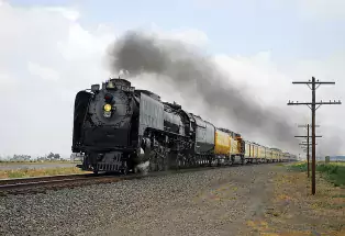 A train streams toward Denver through Platteville, Colorado.