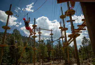 A person climbs ropes on an obstacle course at Colorado Adventure Center in Idaho Springs