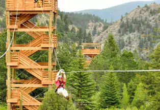 People ziplining from a tower at Colorado Adventure Center in Idaho Springs