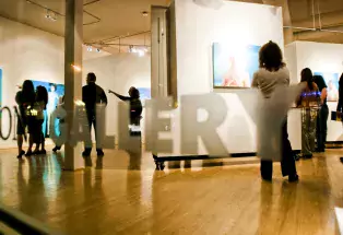 patrons admiring art inside a gallery at the denver art walk