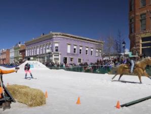 A contestant is pulled behind a horse at the annual Leadville Ski Joring event. A contestant is pulled behind a horse down Main Street at the annual Leadville Ski Joring event.
